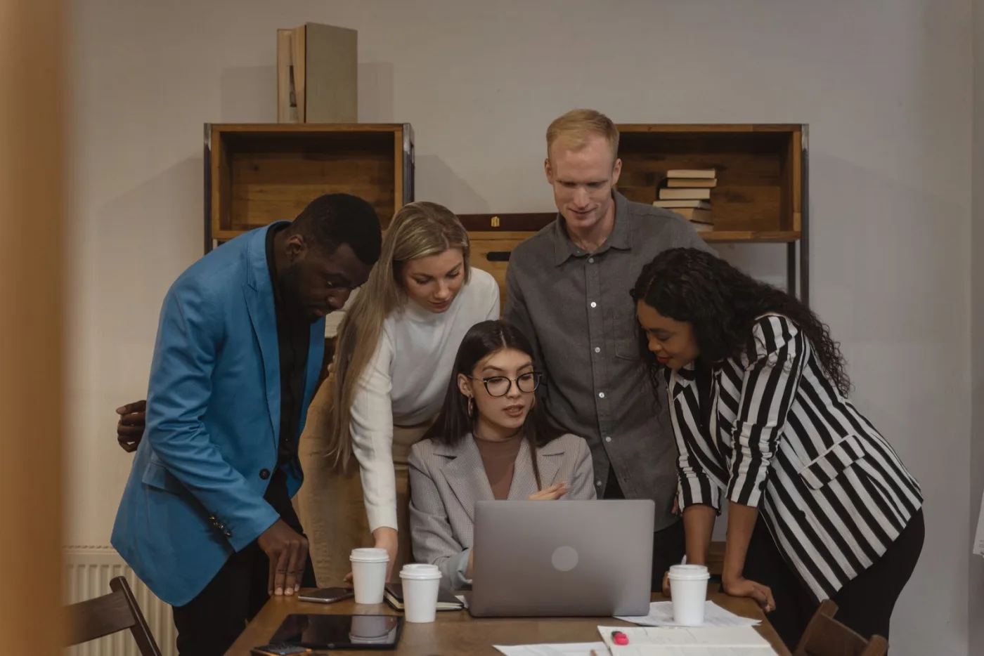 A team planning a software project around a laptop